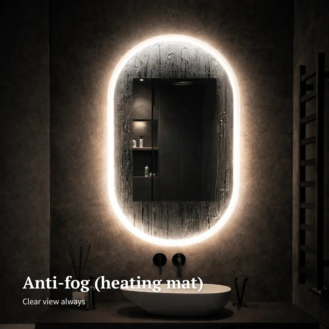 Bathroom with a large oval mirror illuminated by an anti-fog heating mat.