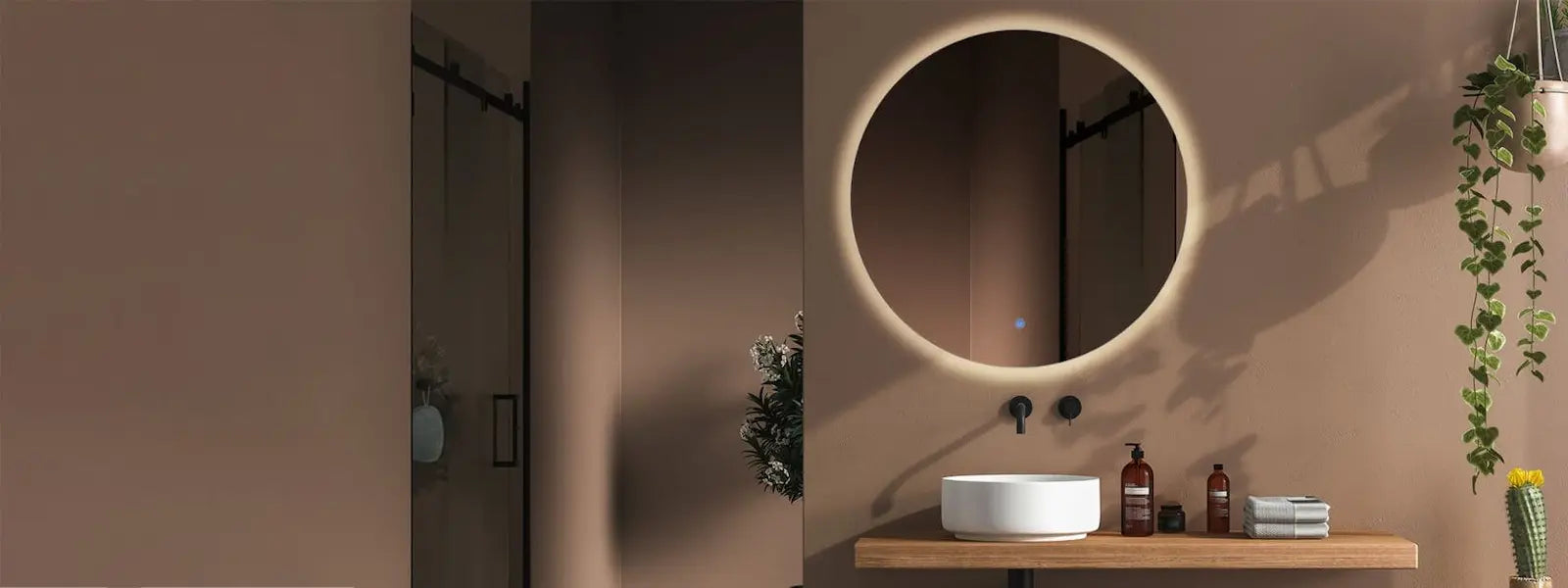 Bathroom setup with a round illuminated mirror and sink.