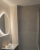 Asymmetrical LED mirror with rear lighting 740x790mm in bathroom